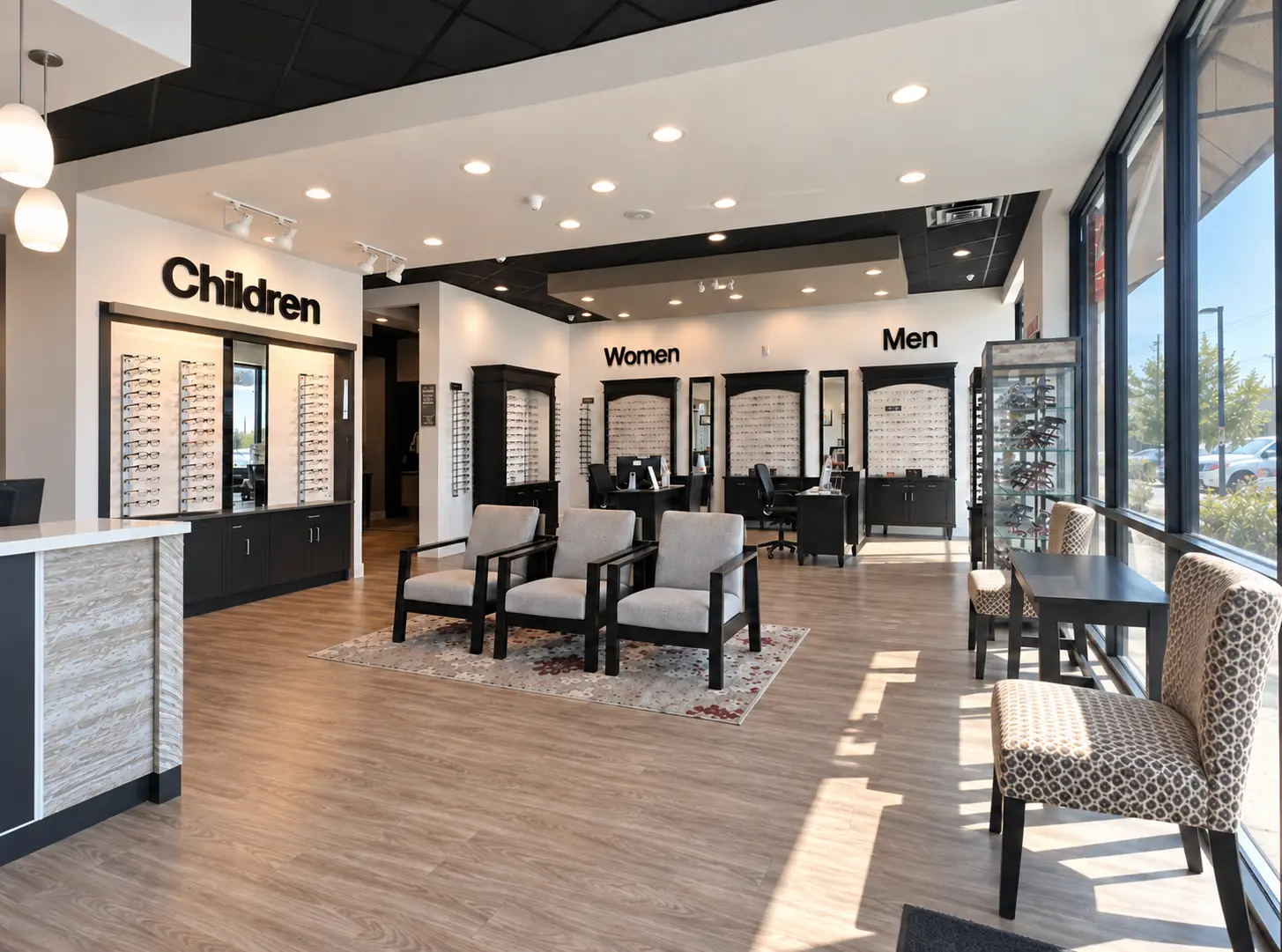 The optical dispensing floor at InSight EyeCare in Cibolo: eyeglass frame displays lining the walls beneath large Children, Women and Men signs, with three grey upholstered chairs on a patterned rug in the middle of the room.
